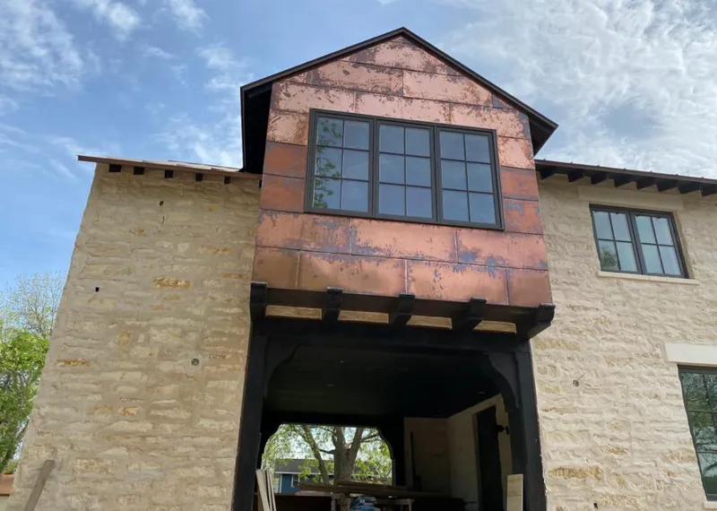 Copper metal panel facade on a stone building for Skylight Installation in Otis Orchards-East Farms